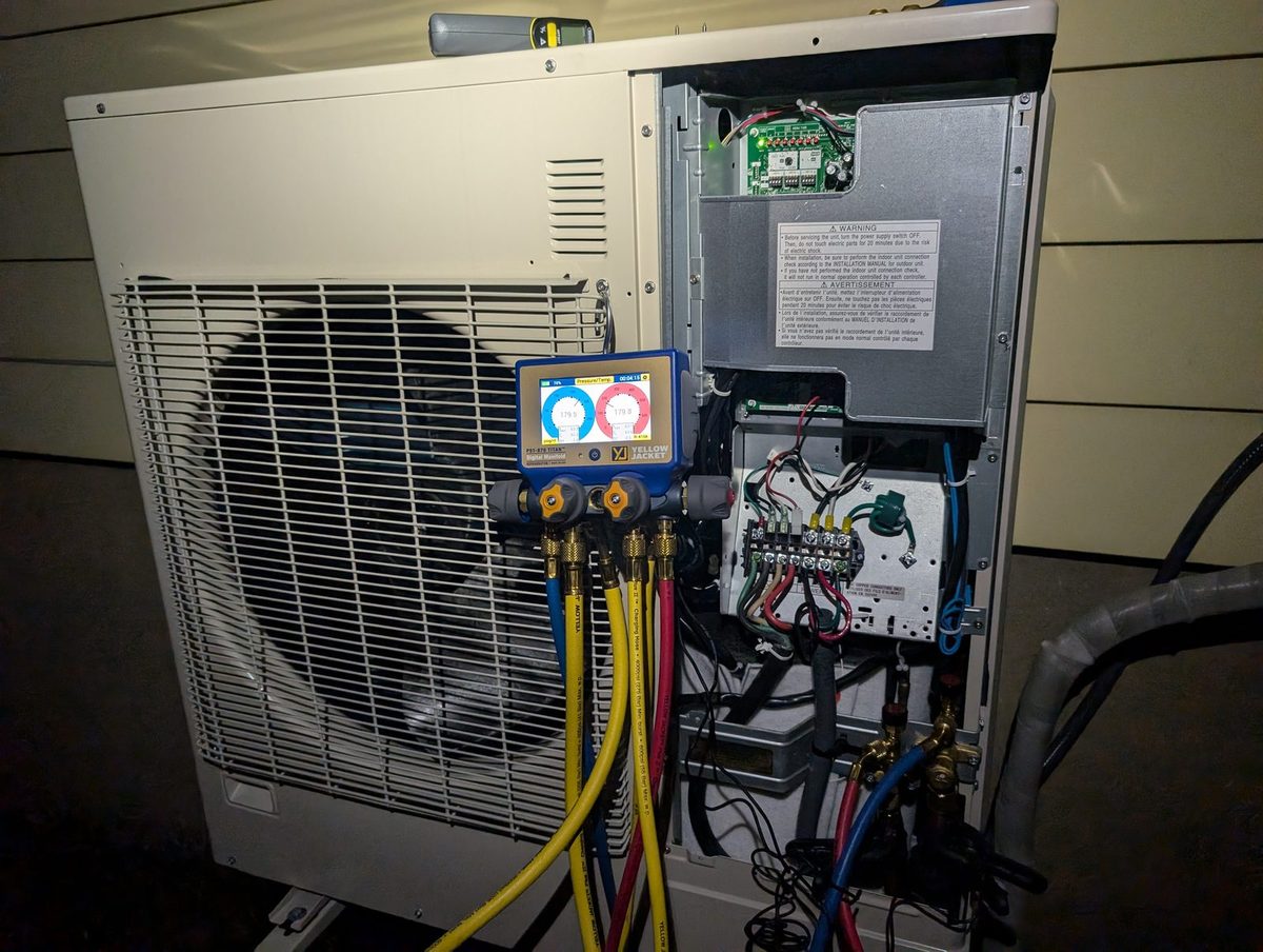 Heat pump outdoor unit open, gauges connected