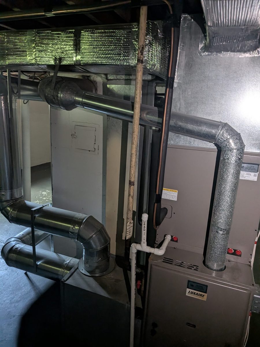 A furnace and its ductwork in a basement